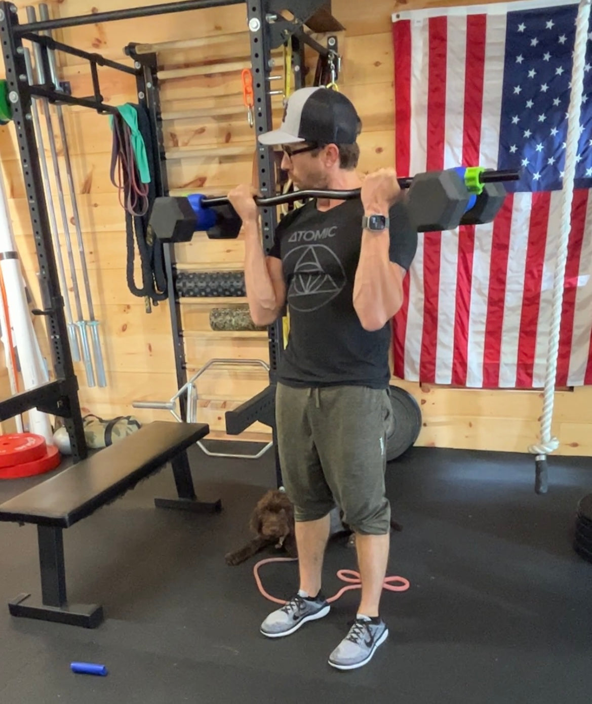 Dualbell Pair connected to an ez curl bar for biceps curls