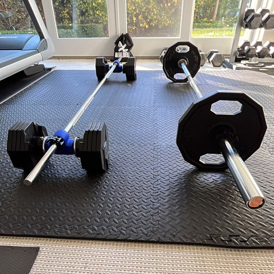 Dualbell Pair set up with adjustable dumbbells on bar compared to standard set up Olympic bar