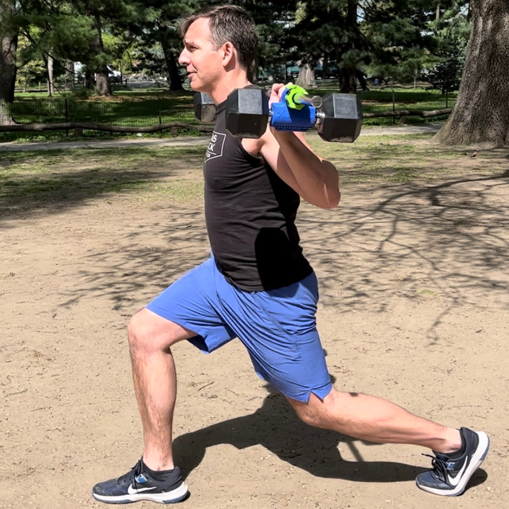 barbell lunges using dualbell for an outdoor workout