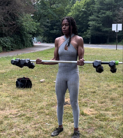 bicep curls being performed outdoors using two pairs of dumbbells, the dumbbell superset on a standard 1" diameter standard bar