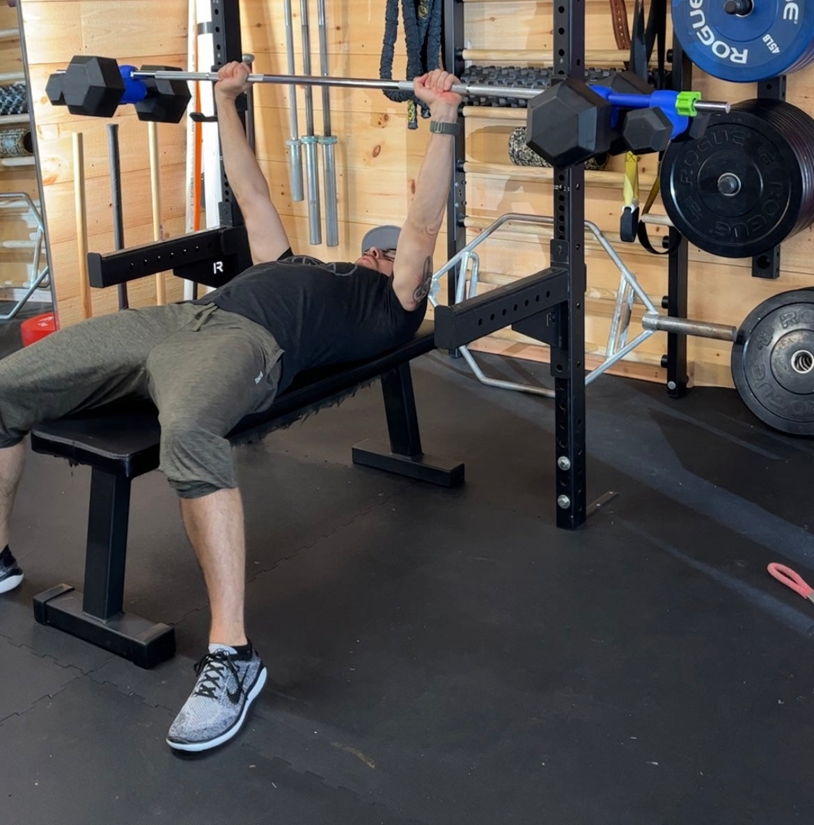 home gym workout bench press being performed 
